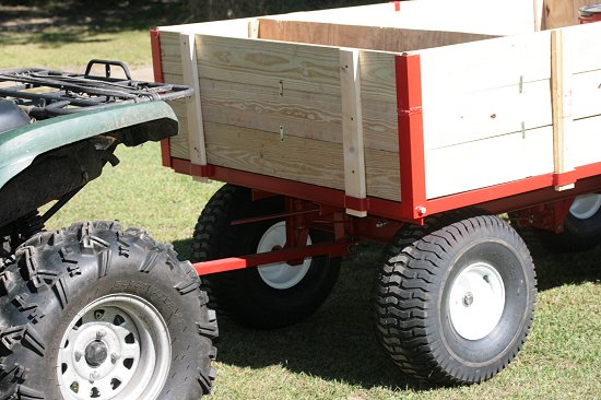 ATV towing firewood cutting trailer